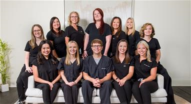 A group of smiling dental office staff