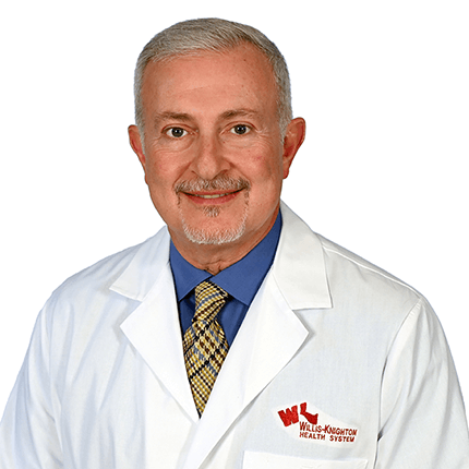 Ghali-Web Smiling man wearing a white lab coat